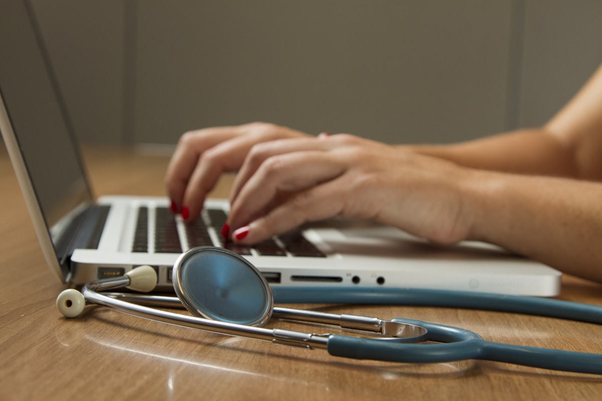 Person ordering lab tests online with stethoscope